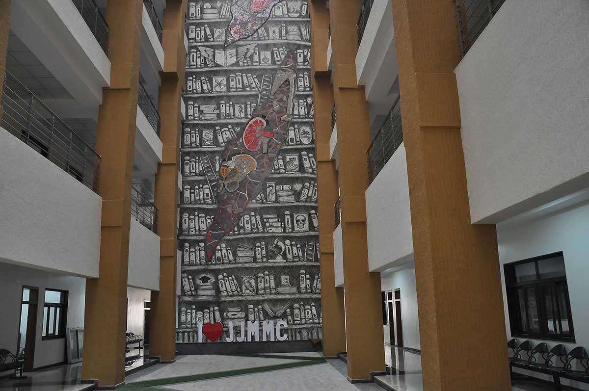 The central atrium, with its mural of bookshelves and “♥ JJMMC”